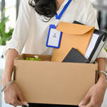 Woman carrying box of office items